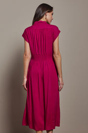 Model Madeline wearing size 10 of The Shirred Waist Detail Dress in colour Raspberry (Red), from the back