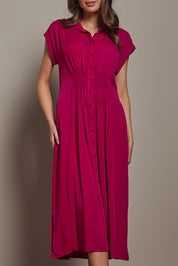 Model Madeline wearing size 10 of The Shirred Waist Detail Dress in colour Raspberry (Red), from the front, cropped image