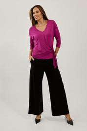 Model Amanda wearing size 10 of The Bamboo Tie Waist Top in colour Berry (Pink), from the front, showing the whole outfit