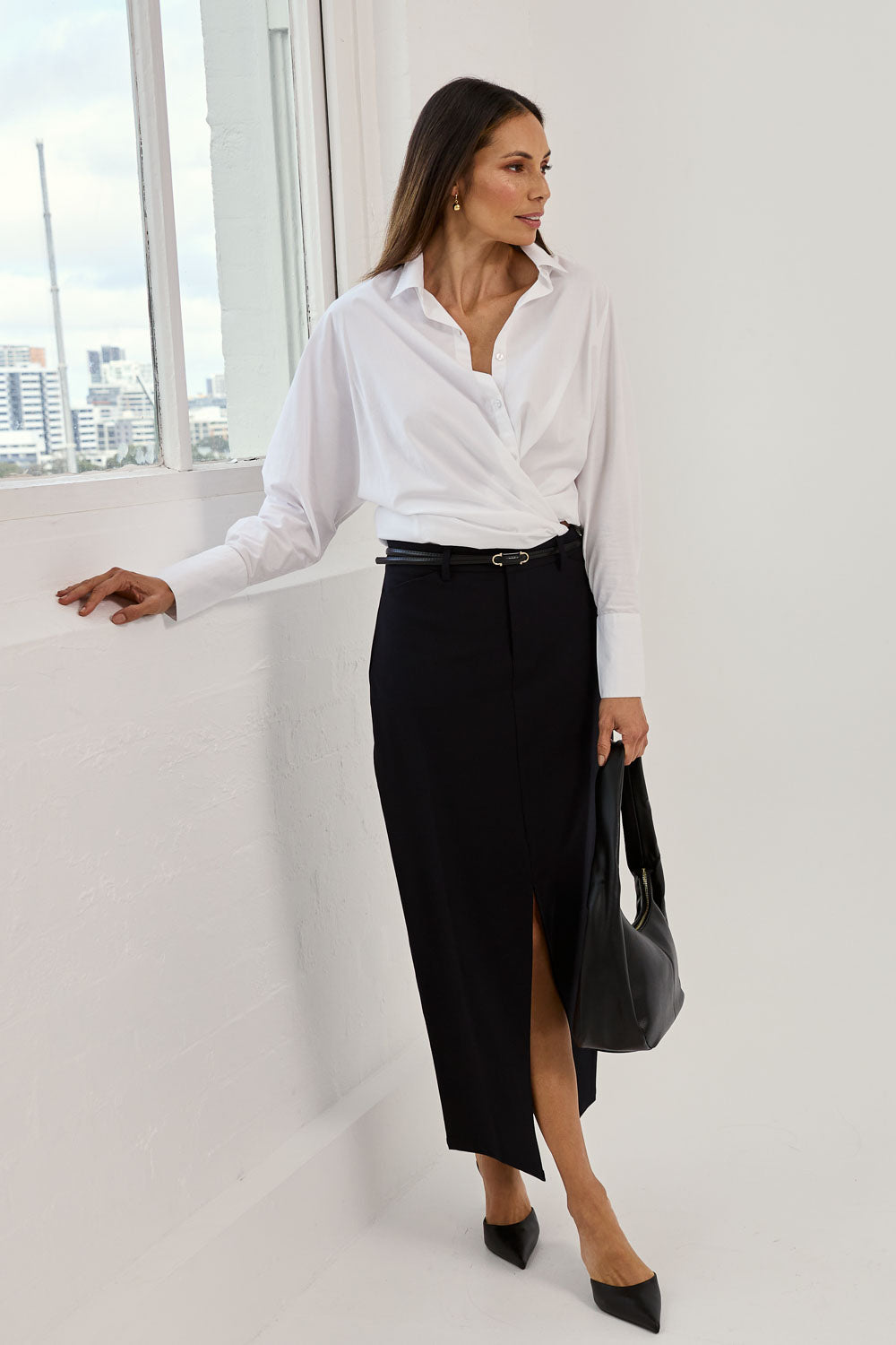 Model Amanda wearing size 10 of The Tailored Maxi Skirt in colour Ink (Blue), from the front, showing the whole outfit