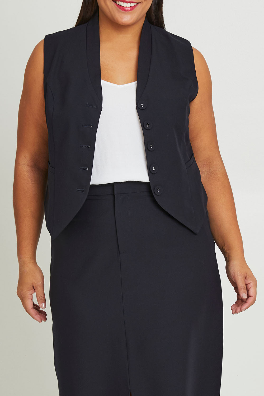 Model Ashleigh wearing size 16 of The Tailored Vest in colour Ink (Blue), from the front, cropped image