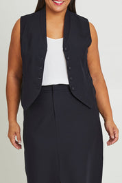 Model Ashleigh wearing size 16 of The Tailored Vest in colour Ink (Blue), from the front, cropped image