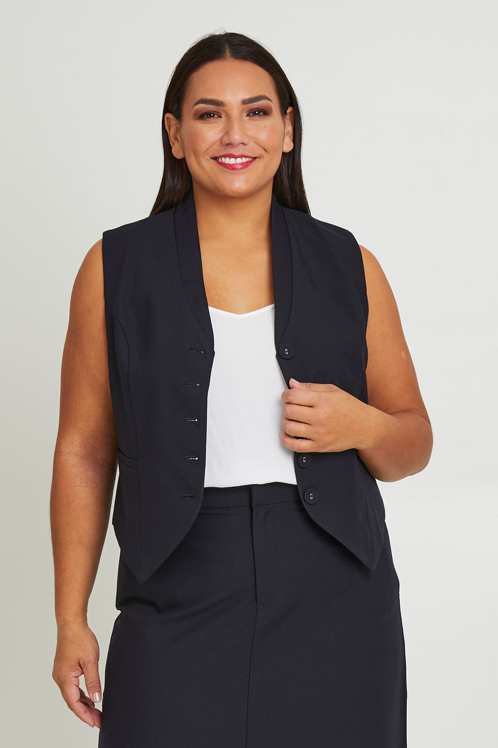 Model Ashleigh wearing size 16 of The Tailored Vest in colour Ink (Blue), from the front, cropped image