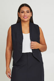 Model Ashleigh wearing size 16 of The Tailored Vest in colour Ink (Blue), from the front, cropped image
