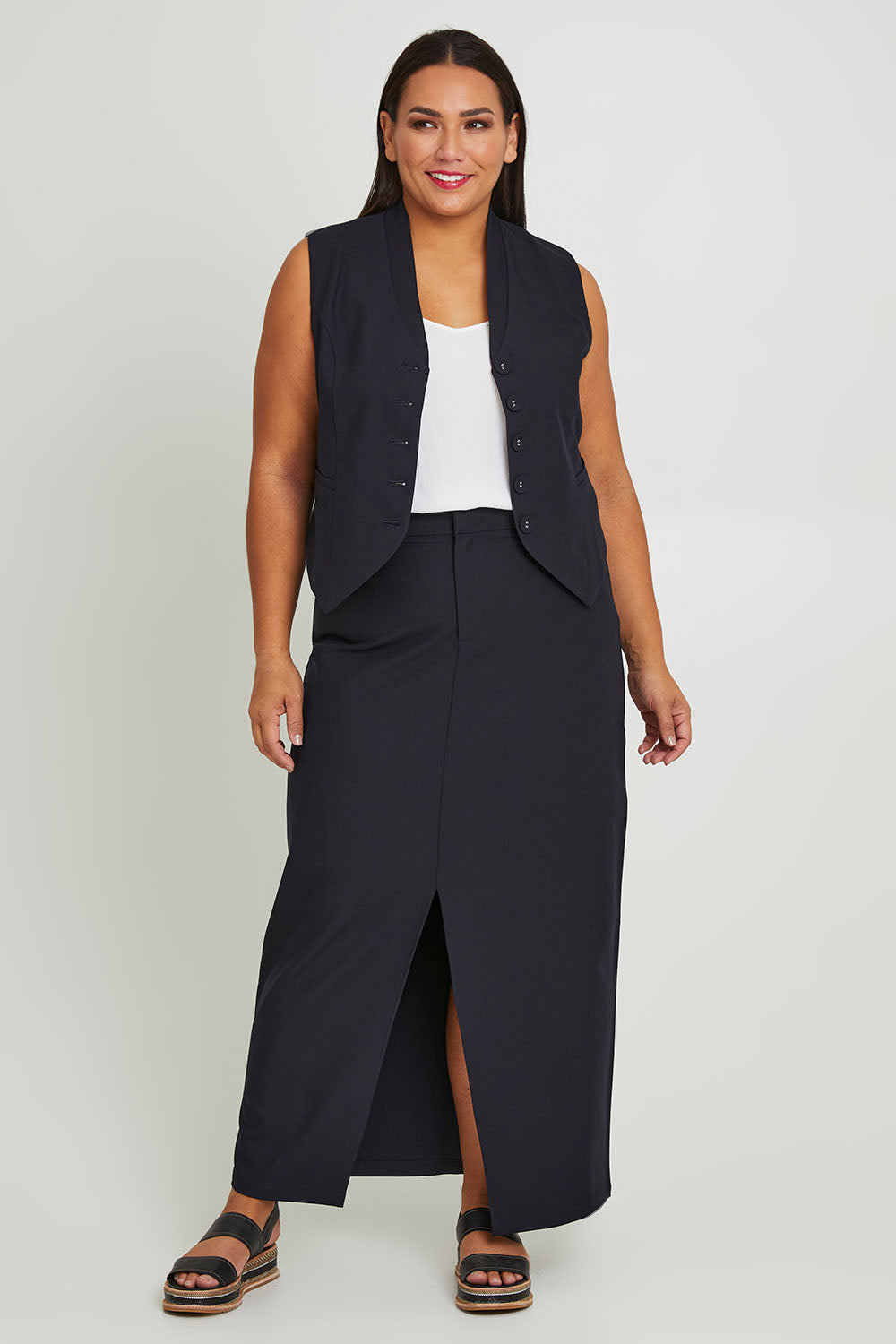 Model Ashleigh wearing size 16 of The Tailored Vest in colour Ink (Blue), from the front, showing the whole outfit