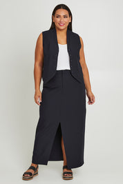 Model Ashleigh wearing size 16 of The Tailored Vest in colour Ink (Blue), from the front, showing the whole outfit