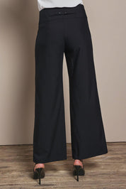 Model Madeline wearing size 10 of The Tailored Pant in colour Black (Black), from the back