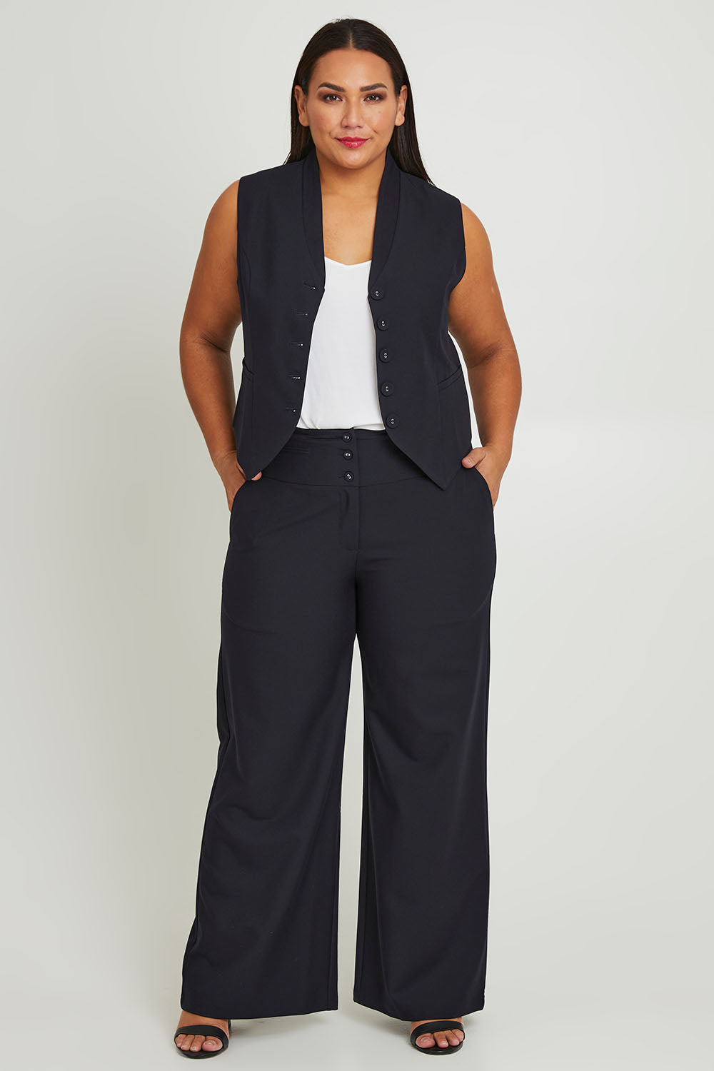 Model Ashleigh wearing size 16 of The Tailored Pant in colour Ink (Blue), from the front, showing the whole outfit