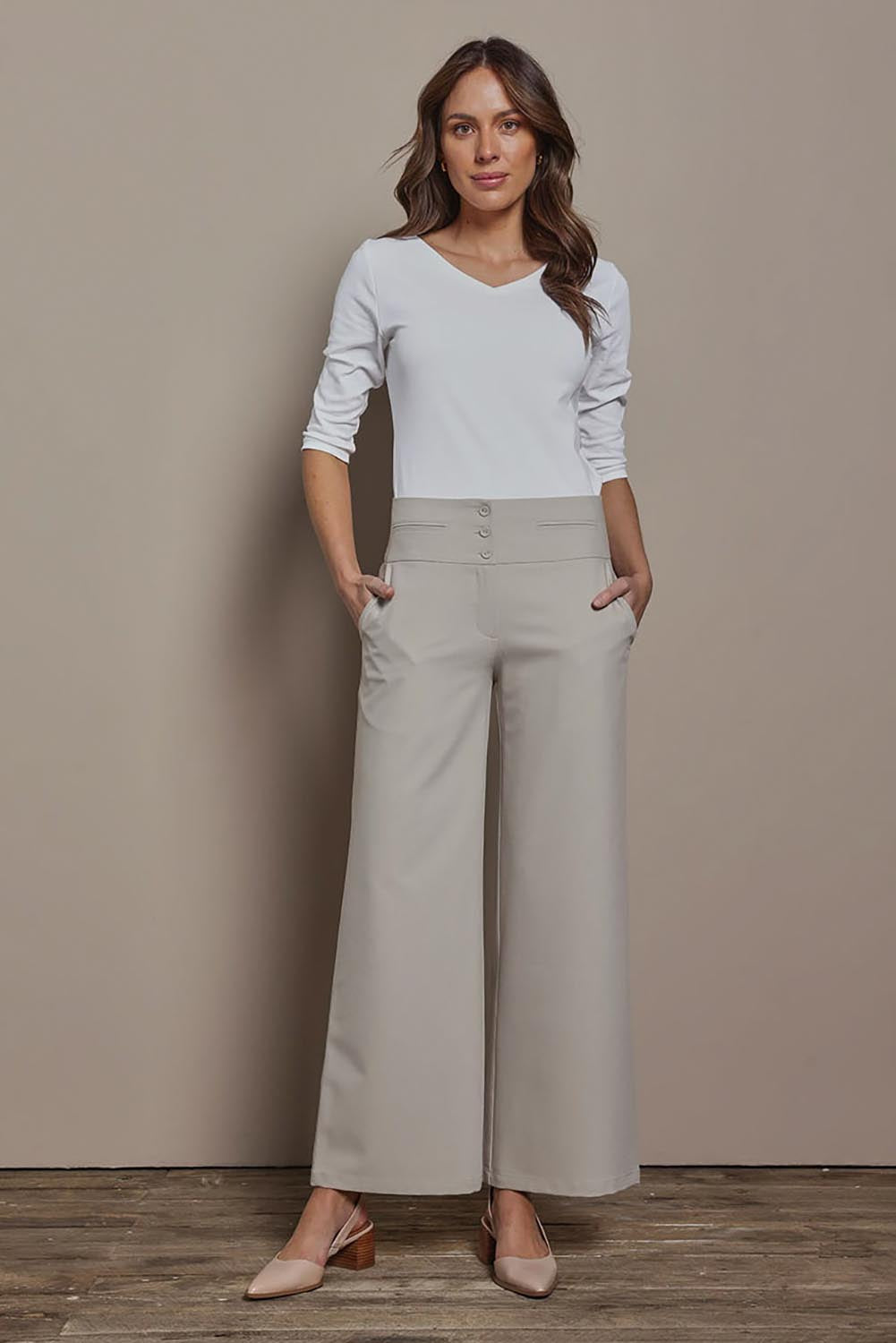 Model Madeline wearing size 10 of The Tailored Pant in colour Pebble, from the front, showing the whole outfit