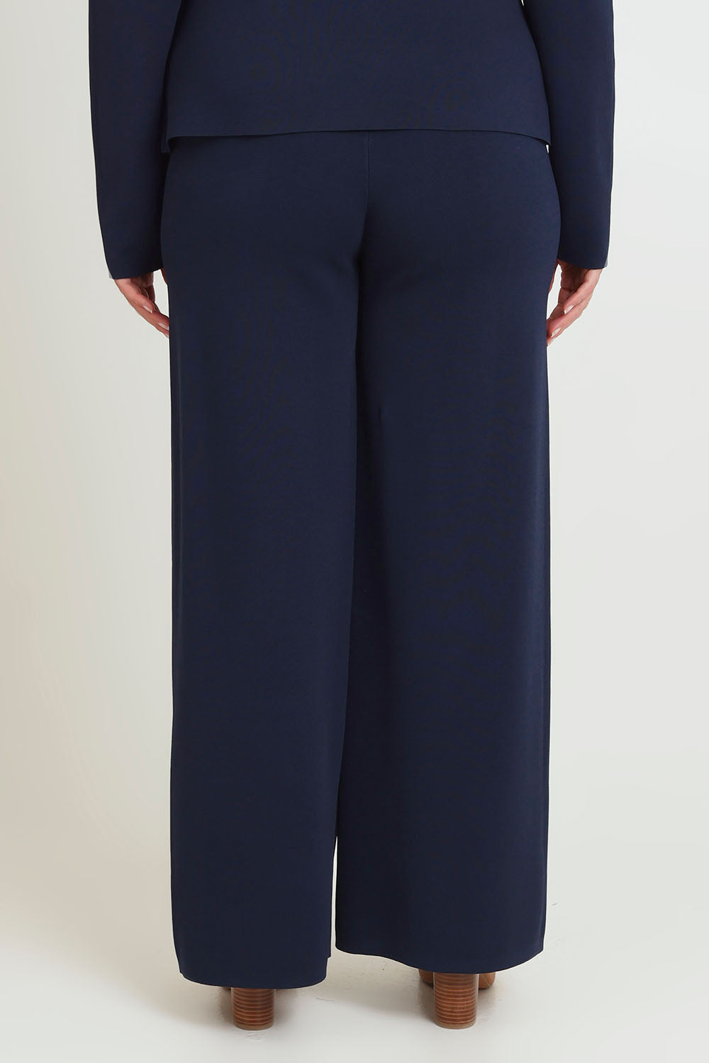 Model Chanel wearing size XL of The Milano Knit Pull On Pant in colour Darknavy (Blue), from the back