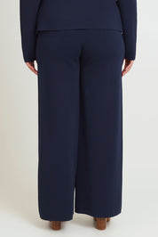 Model Chanel wearing size XL of The Milano Knit Pull On Pant in colour Darknavy (Blue), from the back