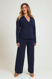 Model Chanel wearing size XL of The Milano Knit Pull On Pant in colour Darknavy (Blue), from the front, showing the whole outfit