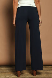 Model Madeline wearing size S of The Milano Knit Pull On Pant in colour Darknavy (Blue), from the back