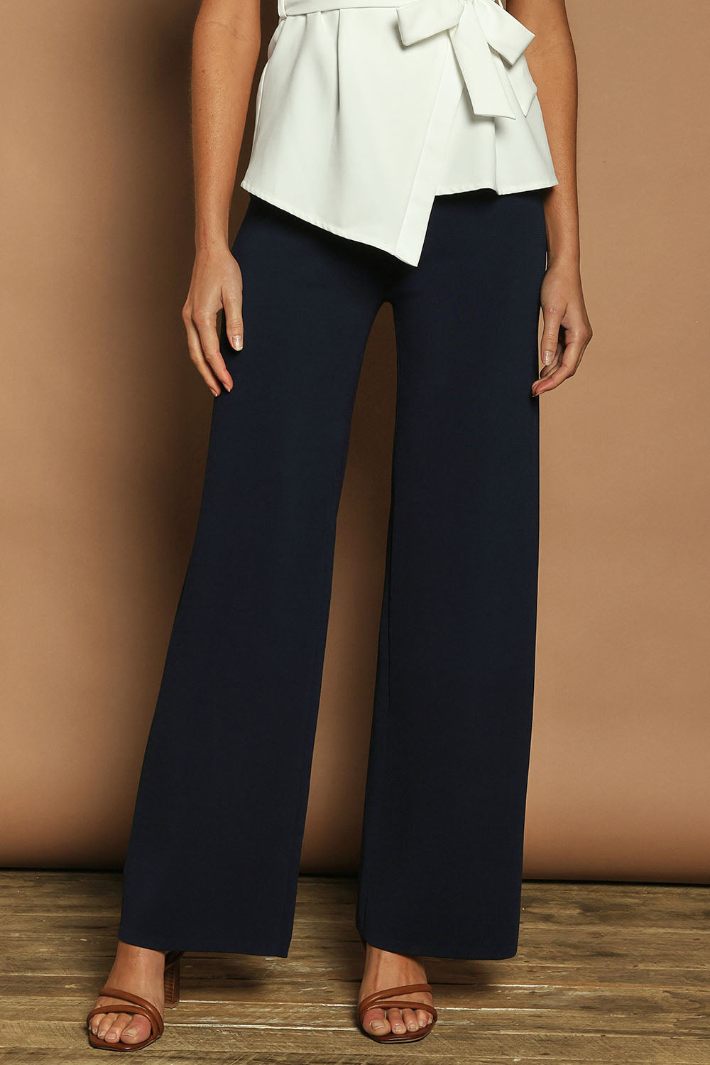 Model Madeline wearing size S of The Milano Knit Pull On Pant in colour Darknavy (Blue), from the front, cropped image