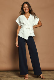 Model Madeline wearing size S of The Milano Knit Pull On Pant in colour Darknavy (Blue), from the front, showing the whole outfit
