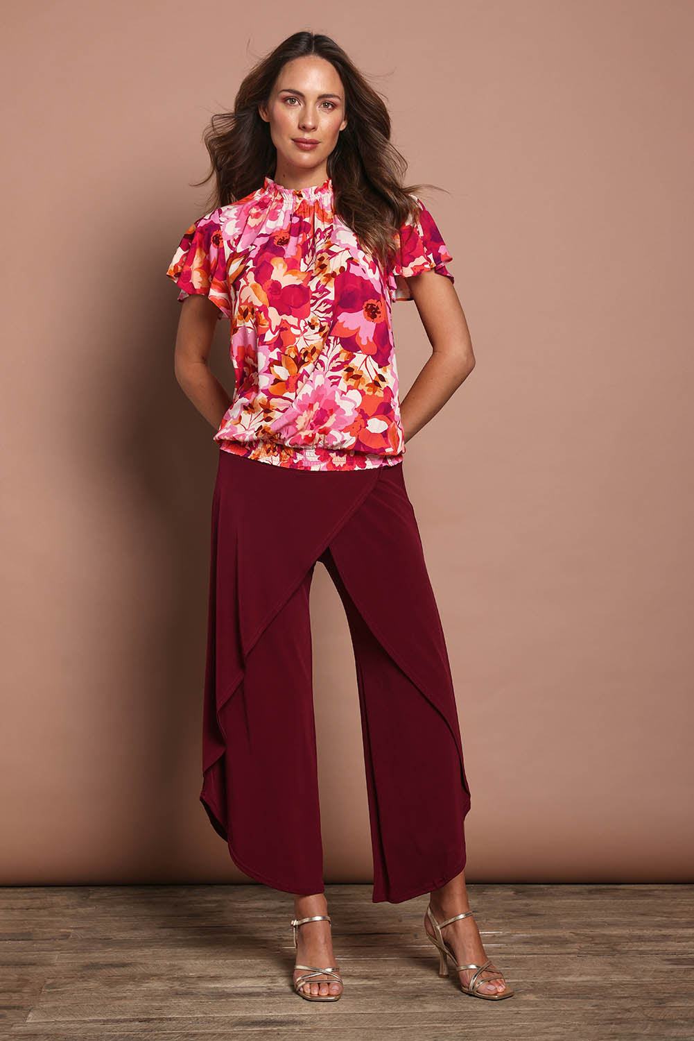 Model Madeline wearing size 10 of The Shirring Detail Printed Top in colour Blooms (Pink), from the front, showing the whole outfit