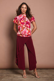 Model Madeline wearing size 10 of The Shirring Detail Printed Top in colour Blooms (Pink), from the front, showing the whole outfit