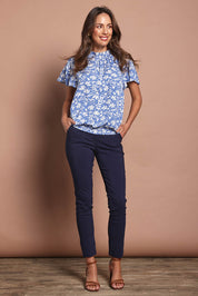 Model Madeline wearing size 10 of The Shirring Detail Printed Top in colour Bluefleur (Blue), from the front, showing the whole outfit