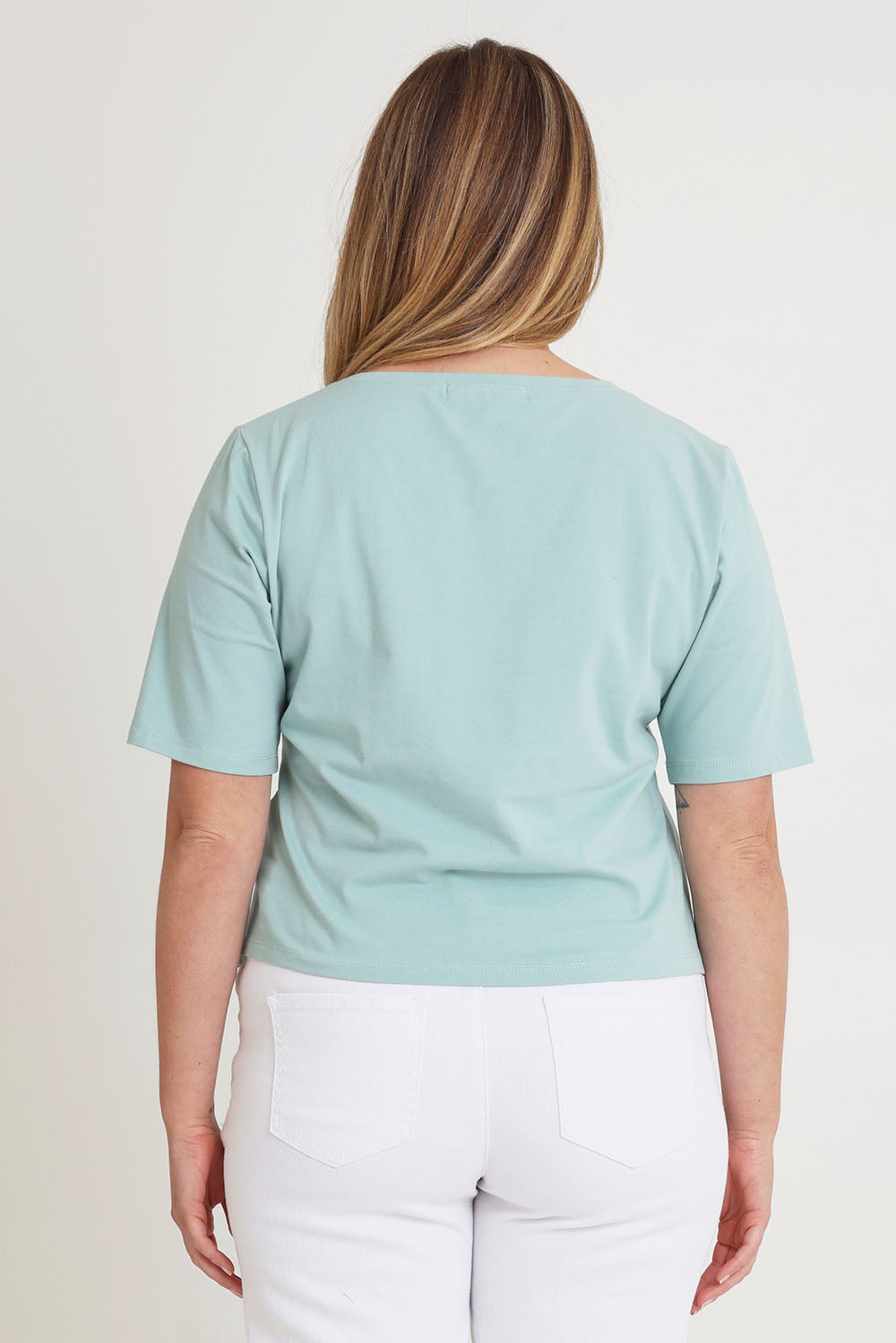 Model Chanel wearing size 16 of The Cotton Stretch Waist Detail Top in colour Duckegg (Blue), from the back