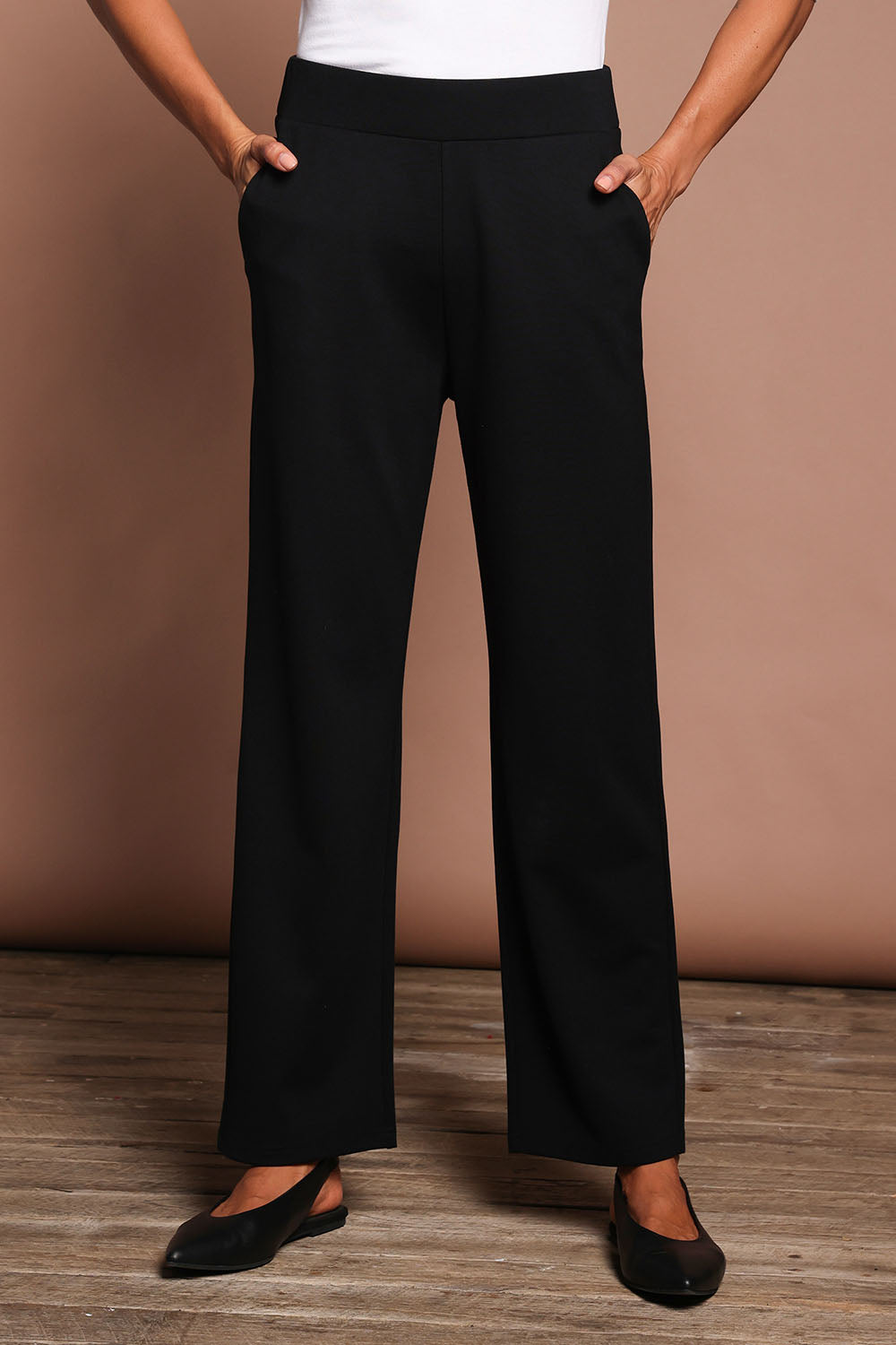 Model Amanda wearing size 10 of The Straight Cut Pull On Ponte Pant in colour Black (Black), from the front, cropped image