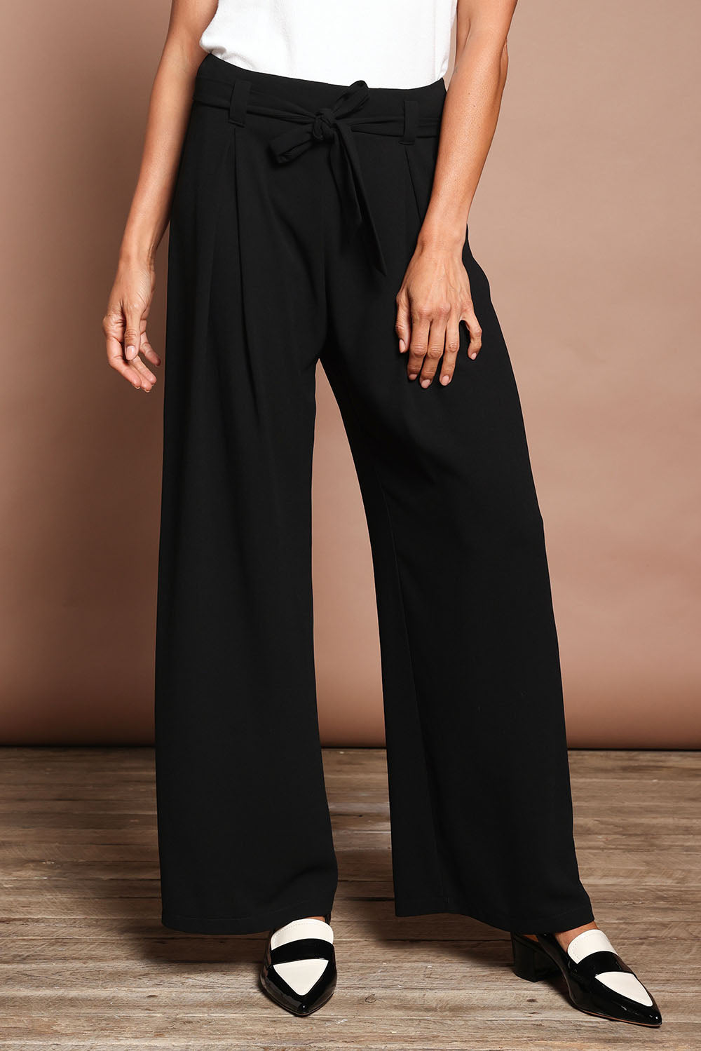 Model Amanda wearing size 10 of The Palazzo Pant in colour Black (Black), from the front, cropped image