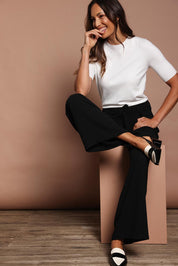 Model Amanda wearing size 10 of The Palazzo Pant in colour Black (Black), from the front, showing the whole outfit