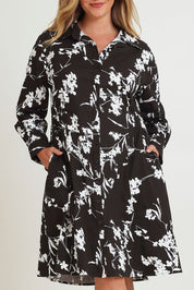 Model Chanel wearing size 16 of The Printed Cotton Stretch Shirt Dress in colour Blackfleur (Black), from the front, cropped image