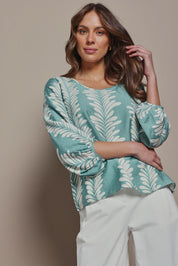Model Madeline wearing size 10 of The Printed Bishop Sleeve Blouse in colour Seafoam (Green), from the front, cropped image