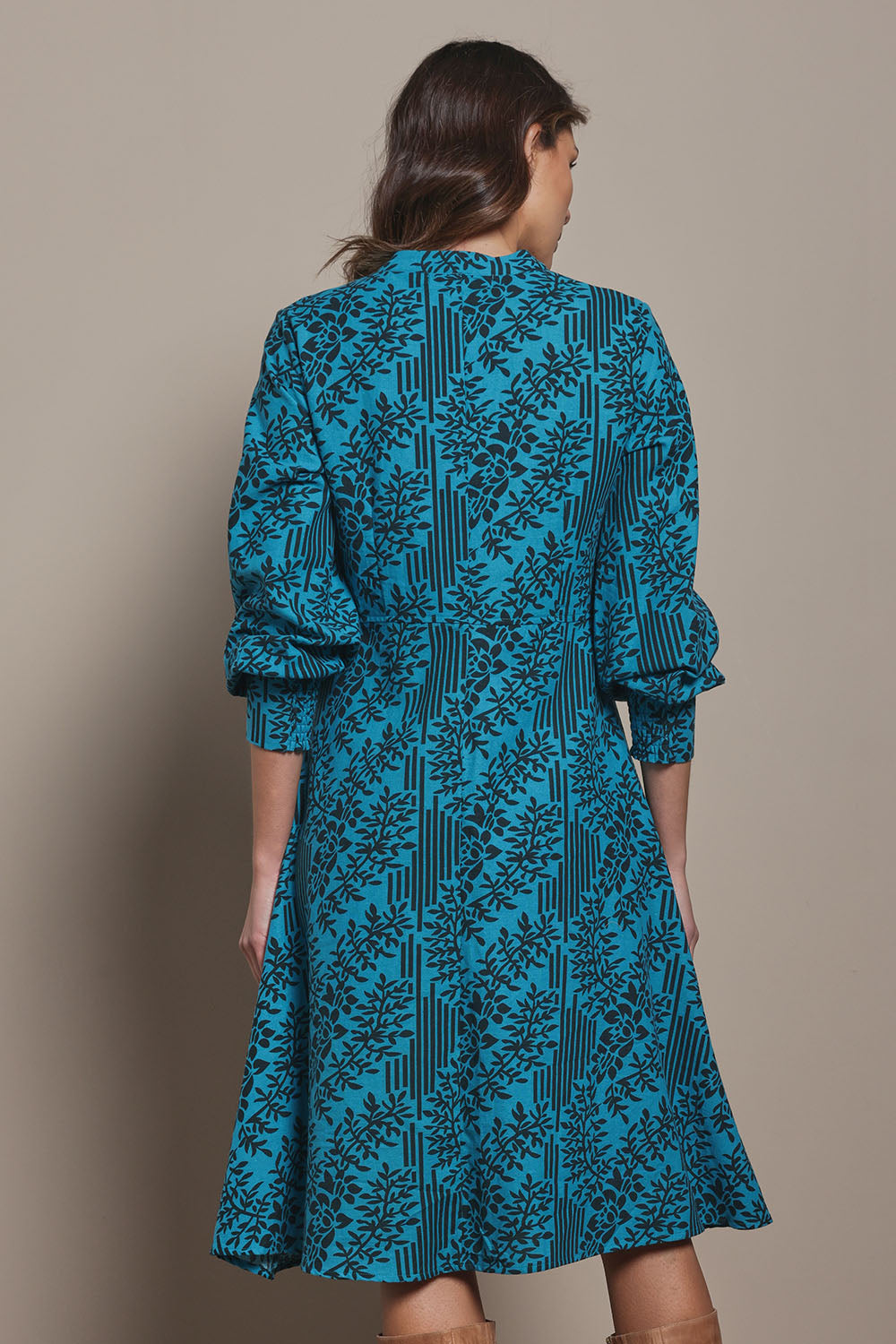 Model Madeline wearing size 10 of The Printed Cotton Button Through Dress in colour Tealbamboo (Blue), from the back