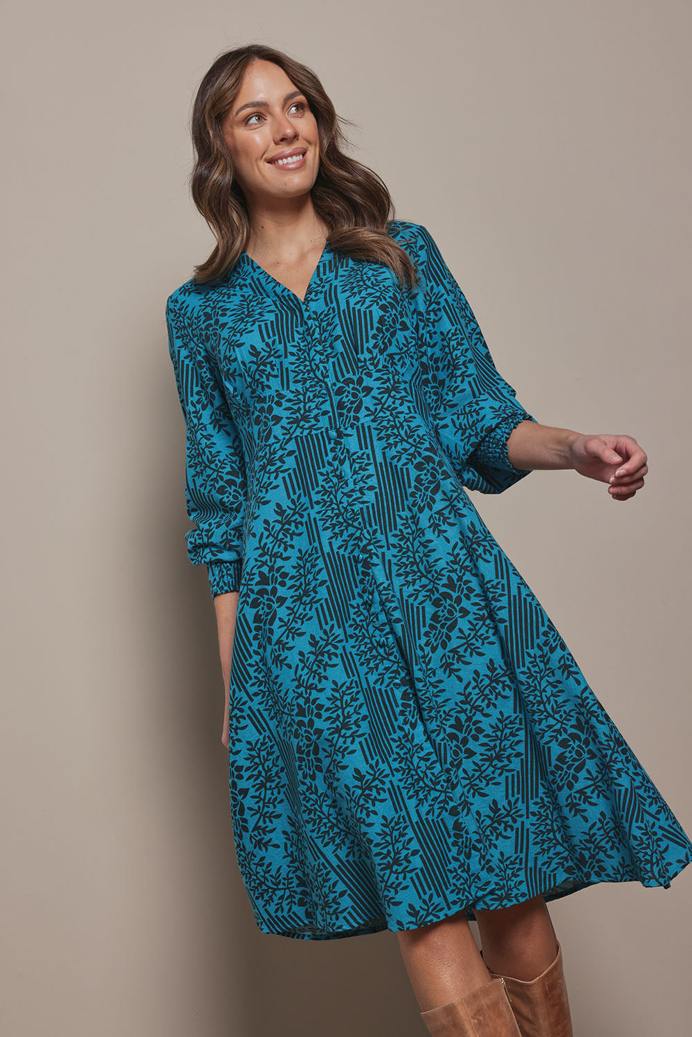 Model Madeline wearing size 10 of The Printed Cotton Button Through Dress in colour Tealbamboo (Blue), from the front, cropped image