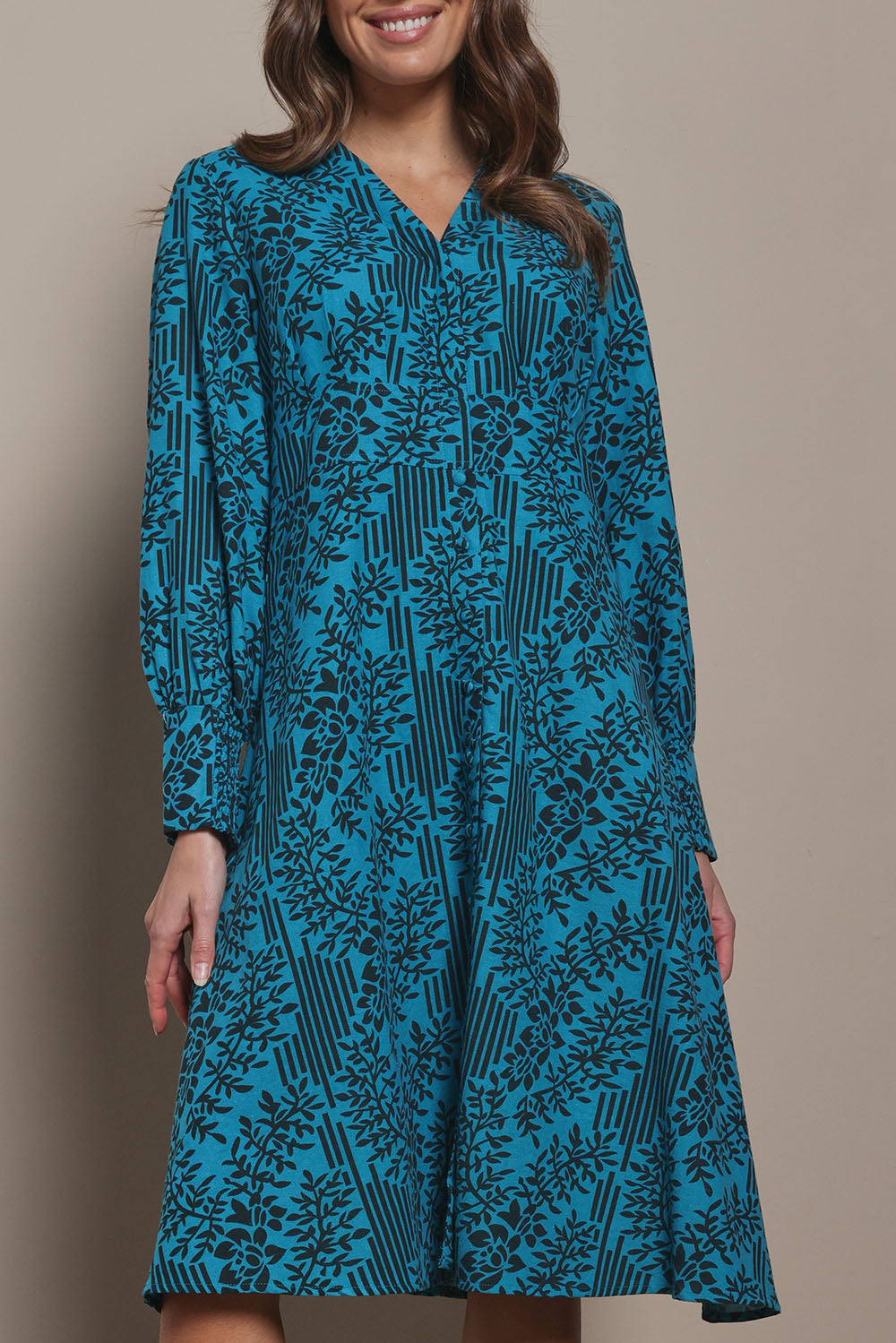 Model Madeline wearing size 10 of The Printed Cotton Button Through Dress in colour Tealbamboo (Blue), from the front, cropped image