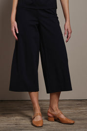 Model Madeline wearing size 10 of The Cotton Blend Pull On Culotte in colour Black (Black), from the front, cropped image