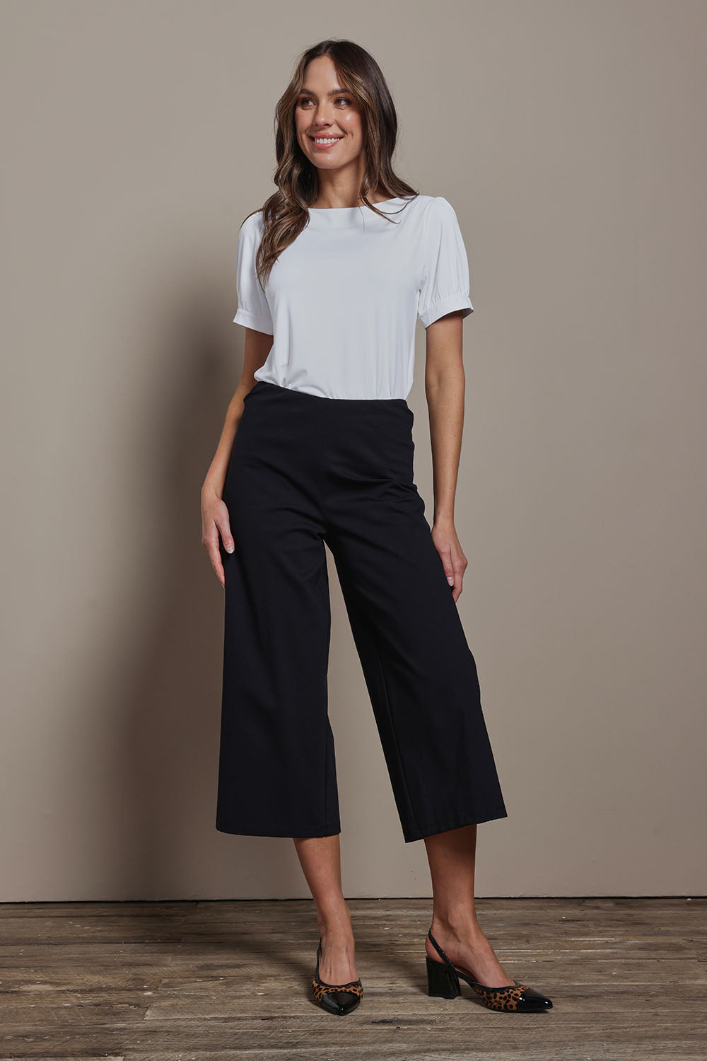 Model Madeline wearing size 10 of The Cotton Blend Pull On Culotte in colour Black (Black), from the front, showing the whole outfit