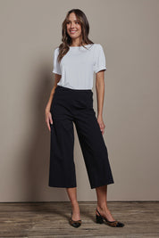 Model Madeline wearing size 10 of The Cotton Blend Pull On Culotte in colour Black (Black), from the front, showing the whole outfit