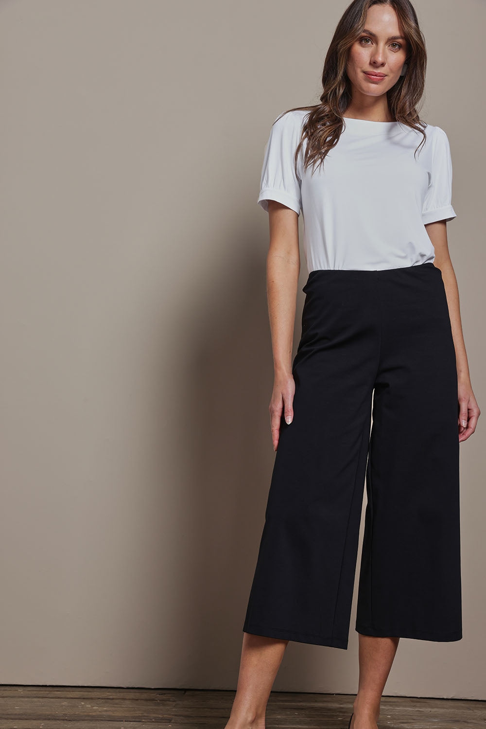 Model Madeline wearing size 10 of The Cotton Blend Pull On Culotte in colour Black (Black), from the front, showing the whole outfit