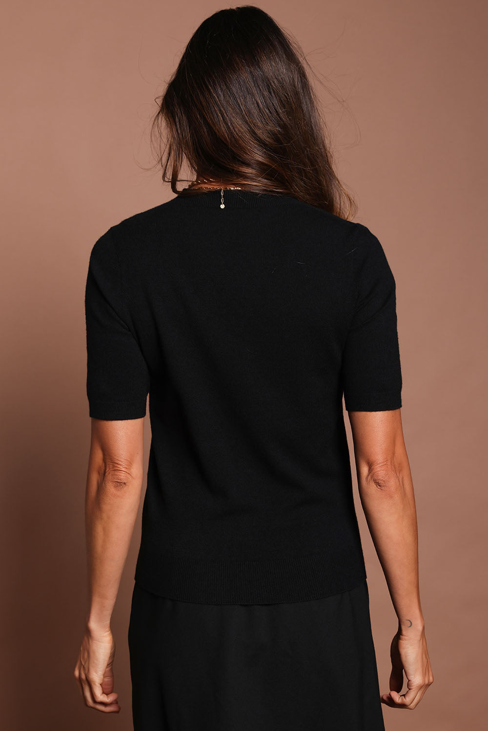 Model Amanda wearing size S of The Seamless Soft Crew Neck Knit in colour Black (Black), from the back