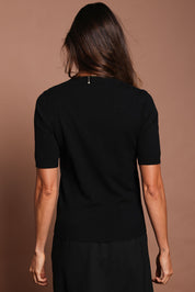 Model Amanda wearing size S of The Seamless Soft Crew Neck Knit in colour Black (Black), from the back