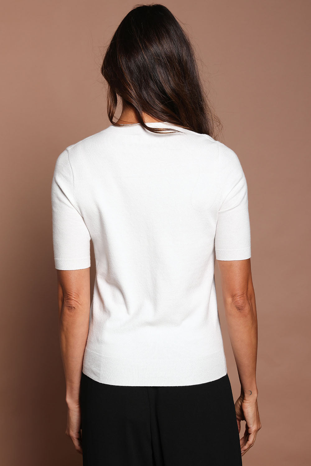 Model Amanda wearing size S of The Seamless Soft Crew Neck Knit in colour Snow (White), from the back