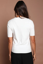 Model Amanda wearing size S of The Seamless Soft Crew Neck Knit in colour Snow (White), from the back