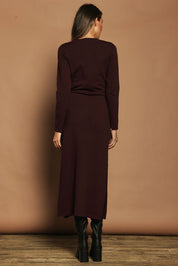 Model Madeline wearing size S of The Tie Waist Faux Wrap Knit Dress in colour Burntplum (Purple), from the back