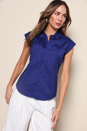 Model Madelinec wearing size 10 of the The Cap Sleeve Cotton Stretch Shirt - Indigoblue in colour Indigoblue, from an angle