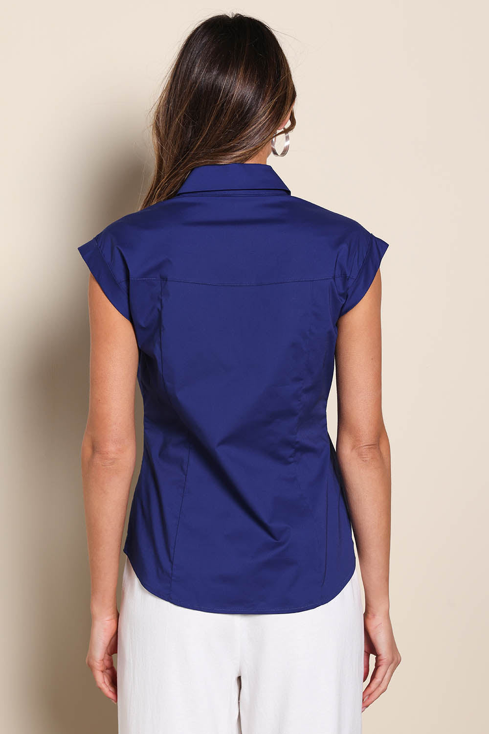 Model Madelinec wearing size 10 of the The Cap Sleeve Cotton Stretch Shirt - Indigoblue in colour Indigoblue, from the back