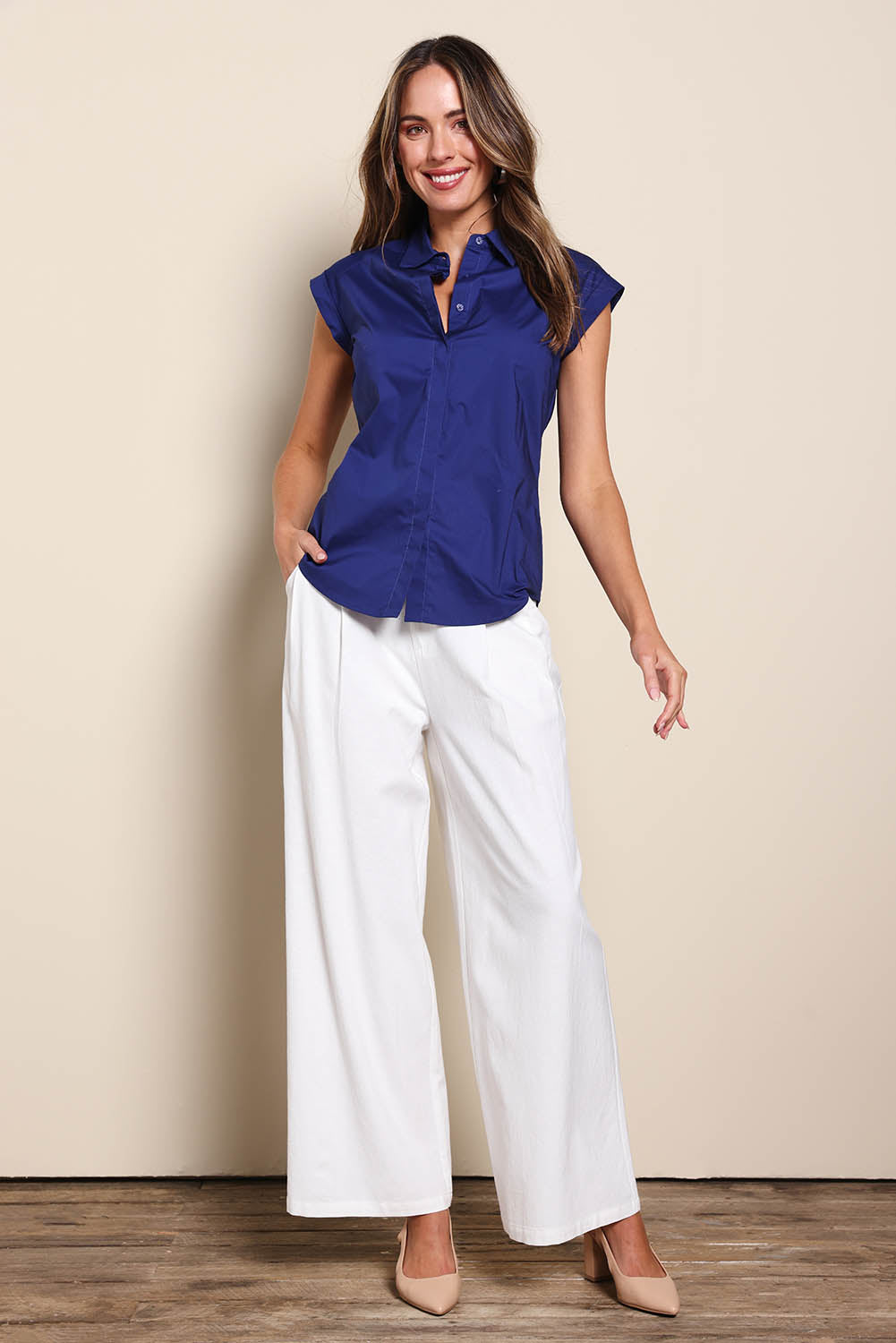 Model Madelinec wearing size 10 of the The Cap Sleeve Cotton Stretch Shirt - Indigoblue in colour Indigoblue, from the front