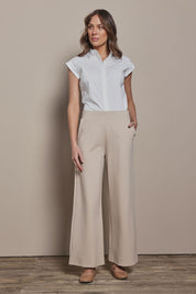 Model Madeline wearing size 10 of The Cap Sleeve Cotton Stretch Shirt in colour White (White), from the front, showing the whole outfit