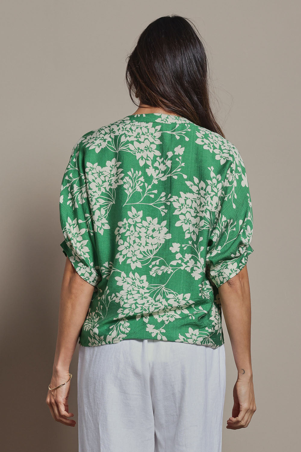Model Amanda wearing size 10 of The Dolman Sleeve Button Up Shirt in colour Greenbloom (Green), from the back