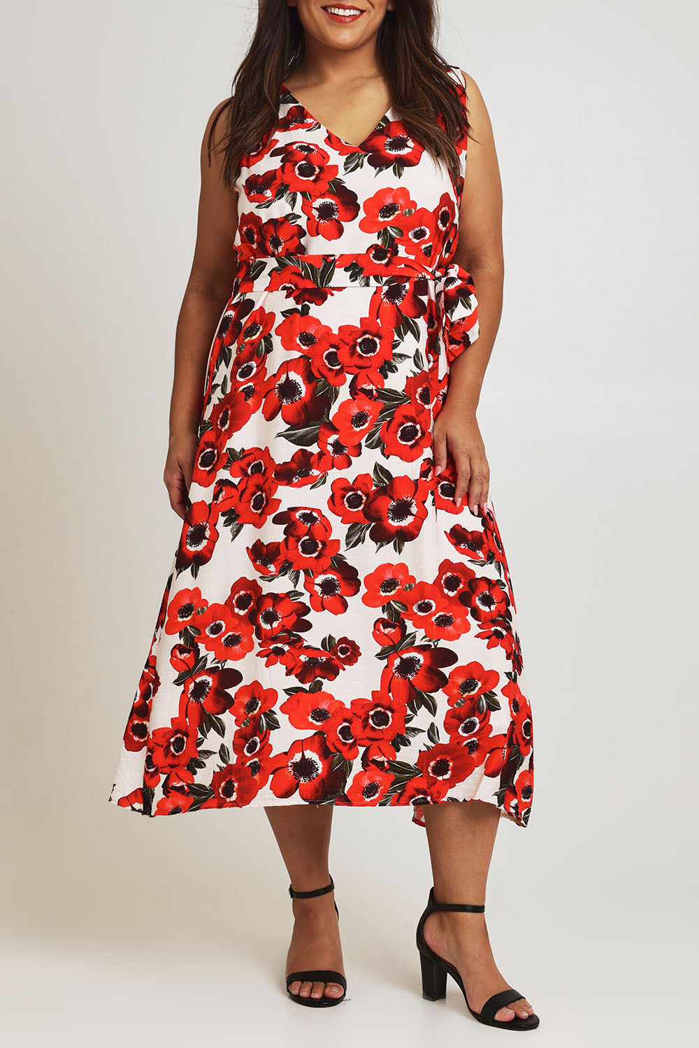 Model Ashleigh wearing size 16 of The Printed V Neck Dress With Sash in colour Redfloral (Red), from the front, cropped image