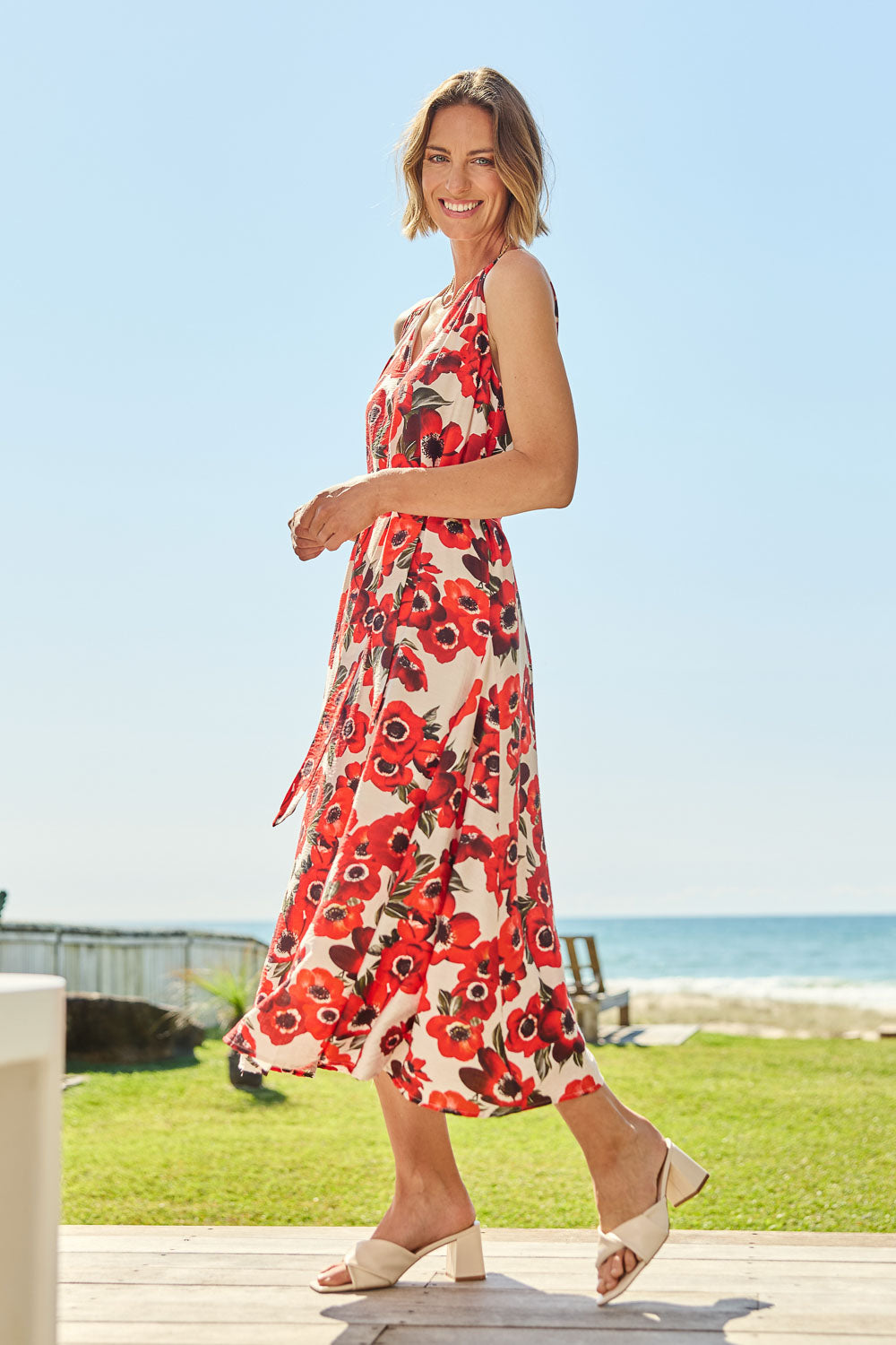 Model Riina wearing size 10 of The Printed V Neck Dress With Sash in colour Redfloral (Red), from the front, showing the whole outfit