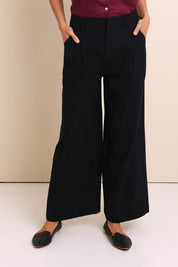 Model Amandam wearing size 10 of the The Linen Blend Tailored Pant - Black in colour Black, in a cropped view