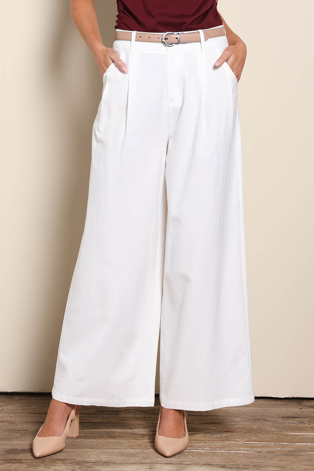 Model Madelinec wearing size 10 of the The Linen Blend Tailored Pant - Snow in colour Snow, in a cropped view