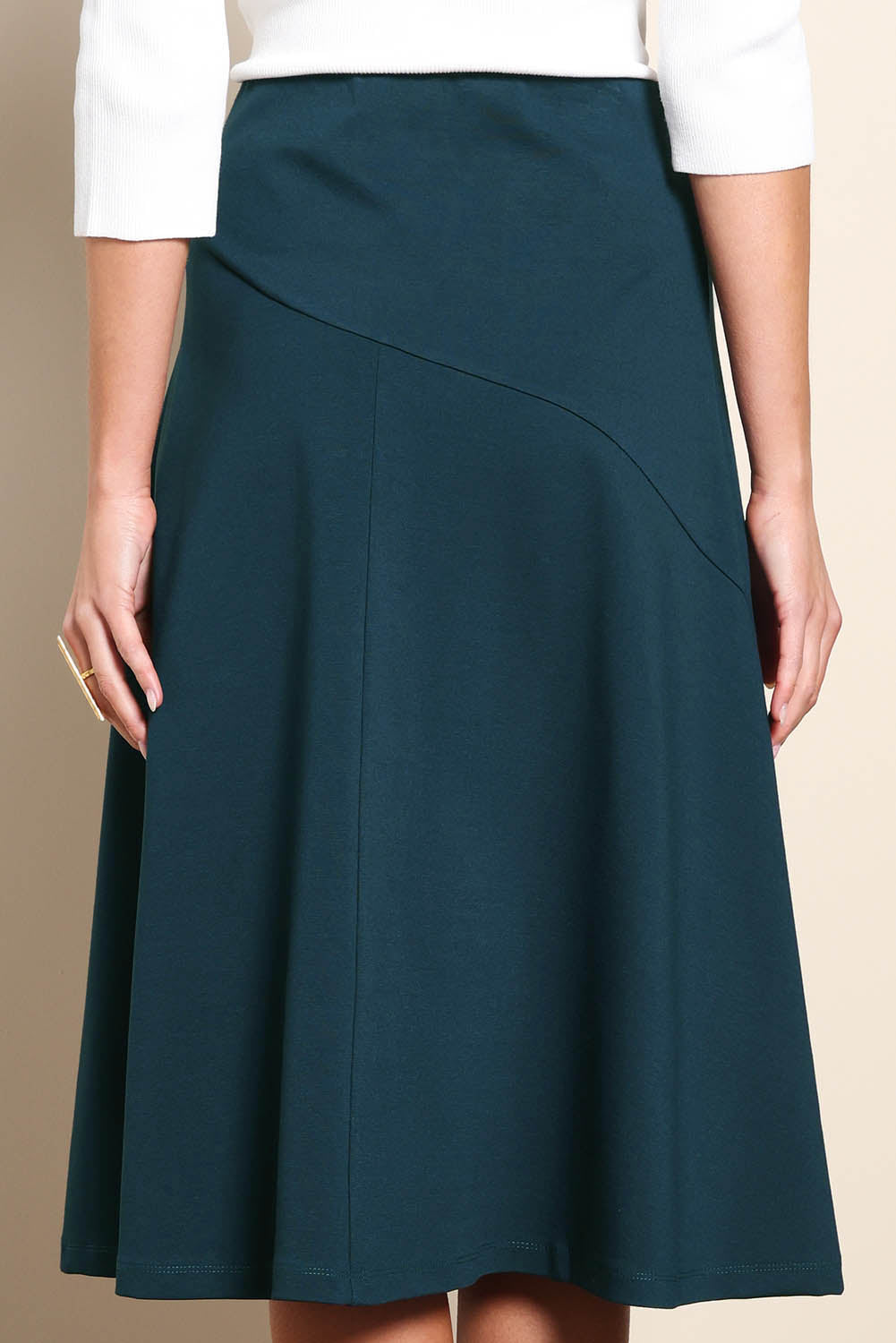 Model Madelinec wearing size 10 of the The Ponte Curve Seam Pull On Skirt – Lagoon in colour Lagoon, in a cropped view